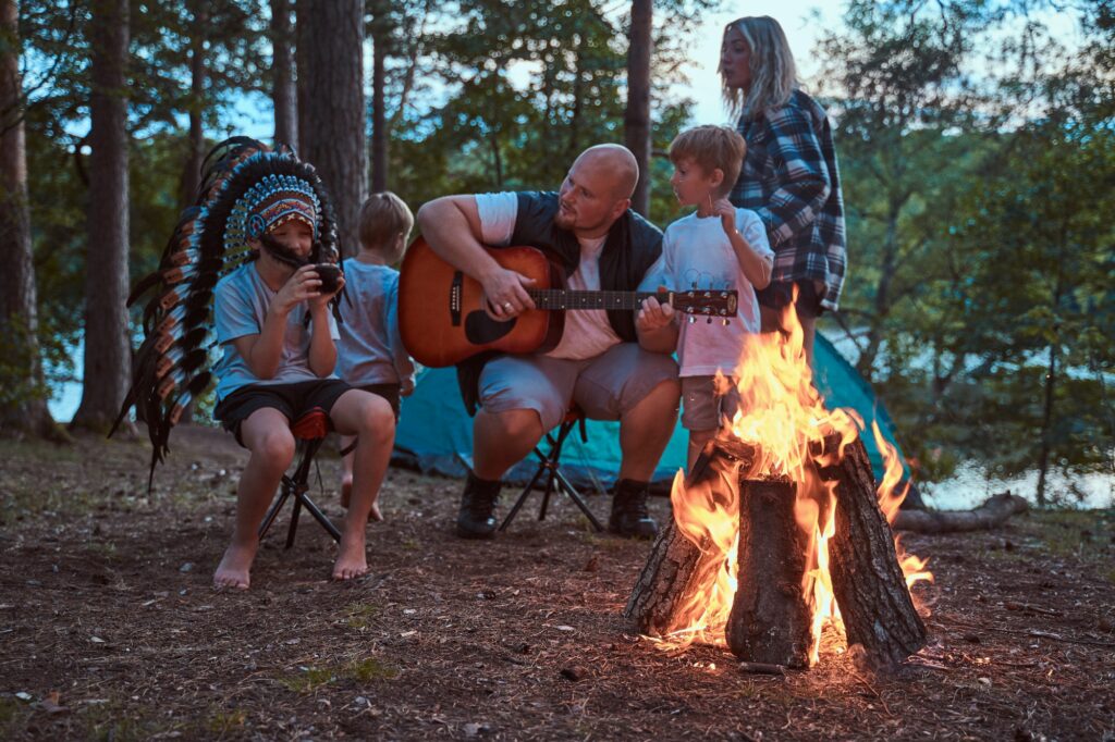 American family camping in woodland on weekend